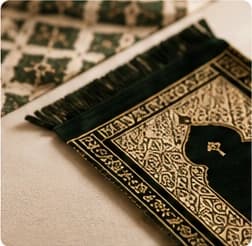 Emerald green velvet prayer mat with ornate border